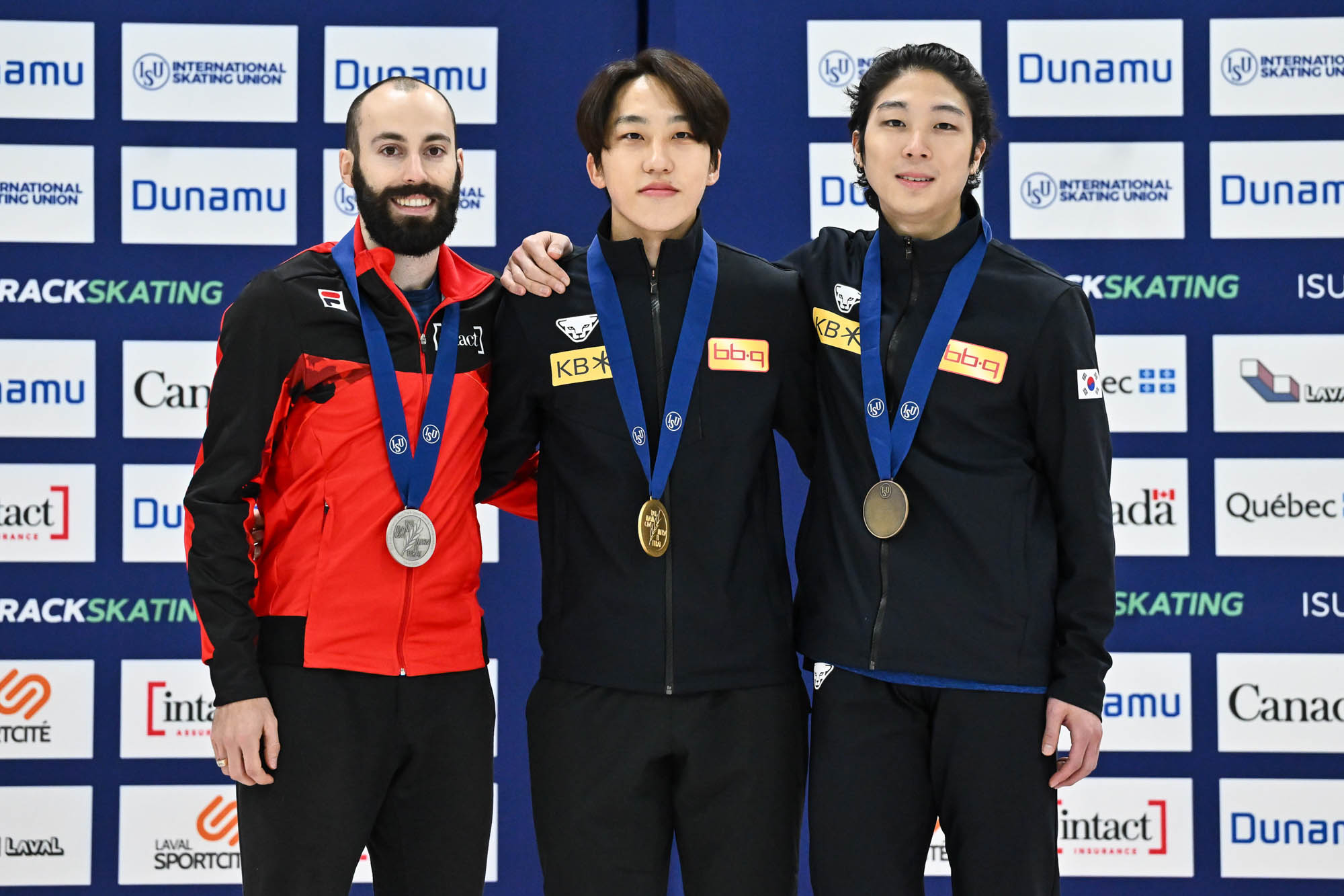 LAVAL, CANADA - NOVEMBER 04:  (L-R) Steven Dubois of Canada, Park Ji Won of the Republic of Korea and Kim Gun Woo of the Republic of Korea pose with their medals after competing in the men’s 1500 m final during the ISU Four Continents Short Track Speed Skating Championships at Place Bell on November 4, 2023 in Laval, Quebec, Canada.  (Photo by Minas Panagiotakis - International Skating Union/International Skating Union via Getty Images)